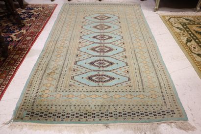 Wool carpet with turquoise background and...