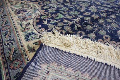 Oriental wool rug with blue background, signed....