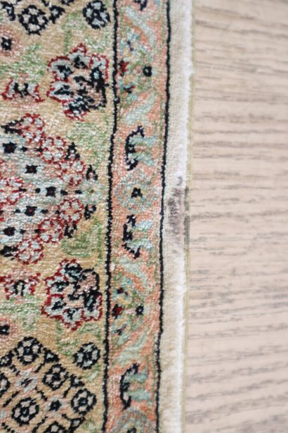 Wool and silk carpet with beige background...