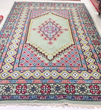 Wool carpet with geometric design on a blue...