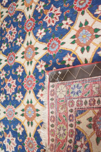 Wool carpet with beige background and flower...