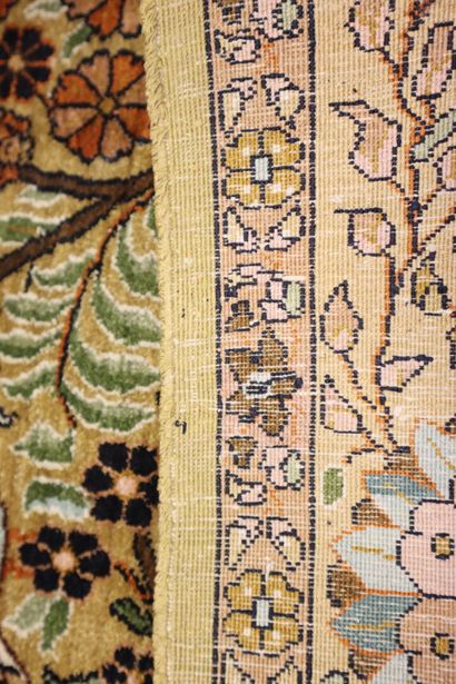 * Oriental silk carpet with beige background...