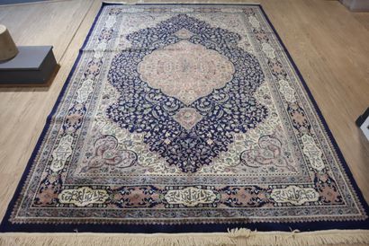 Oriental wool rug with blue background, signed....
