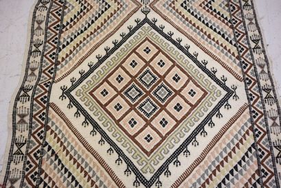 TUNISIA. Wool carpet with beige background...