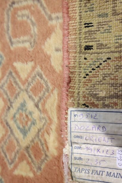 Oriental wool carpet with pink background....