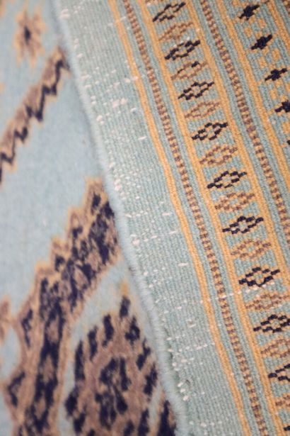 Wool carpet with turquoise background and...