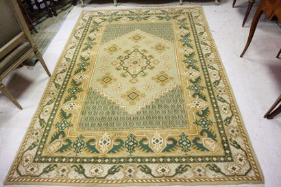 Wool carpet with beige background and stylized...