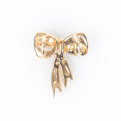Two-tone gold bow pendant set with two round...