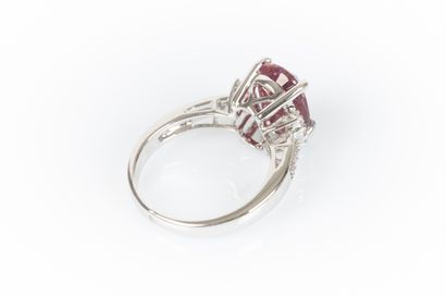 White gold ring set with an oval ruby weighing...
