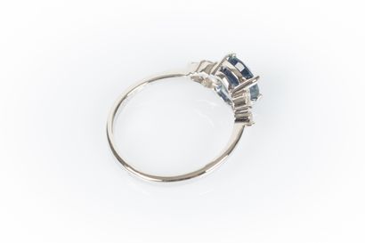 White gold ring set with an oval sapphire...
