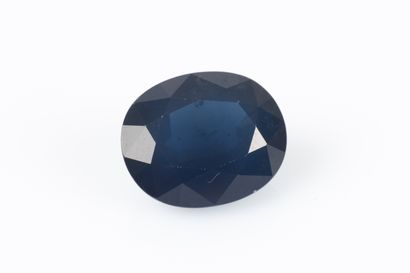 Oval blue sapphire on paper with certificate...