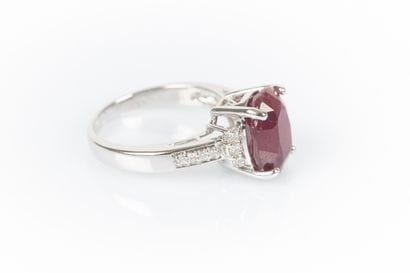 White gold ring set with an oval ruby weighing...