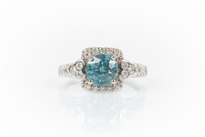 White gold ring set with a round blue zirconia...