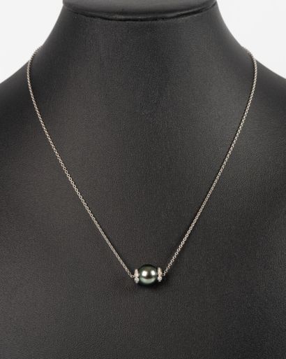 White gold pendant on its chain adorned with...