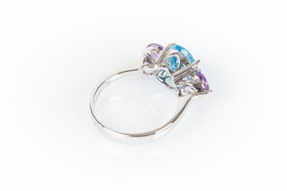 White gold ring set with an oval topaz weighing...