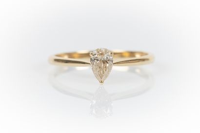 Yellow gold solitaire set with a pear-shaped...