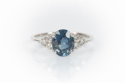 White gold ring set with an oval sapphire...
