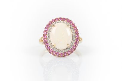 Two-tone gold ring set with an oval cabochon...