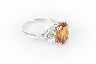 White gold ring set with an oval citrine...