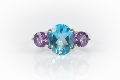 White gold ring set with an oval topaz weighing...