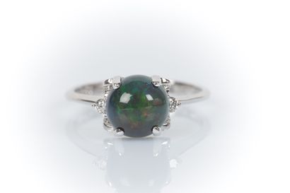 White gold ring set with a round cabochon...