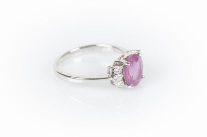 White gold ring set with an oval pink sapphire...