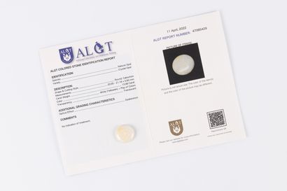 Round crystal opal cabochon on paper with...