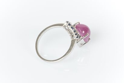 White gold ring centered with an oval cabochon...