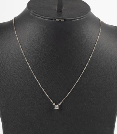 White gold necklace set with a diamond weighing...