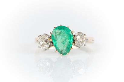 Two-tone gold ring set with a drop emerald...