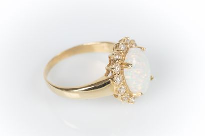 Yellow gold daisy ring set with an oval cabochon...