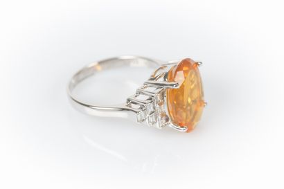 White gold ring set with a fire opal weighing...