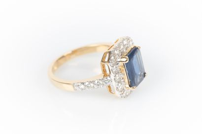 Two-tone gold ring set with an emerald-cut...
