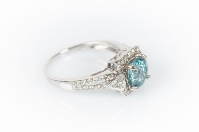 White gold ring set with a round blue zirconia...