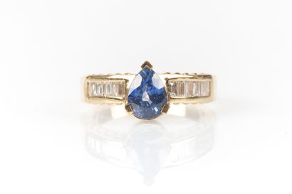 Yellow gold ring centered with a pear-shaped...