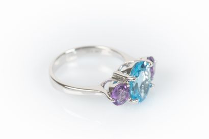 White gold ring set with an oval topaz weighing...