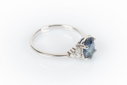 White gold ring set with an oval sapphire...