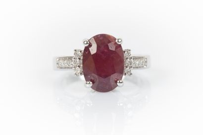 White gold ring set with an oval ruby weighing...