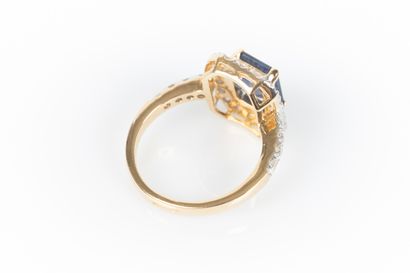 Two-tone gold ring set with an emerald-cut...