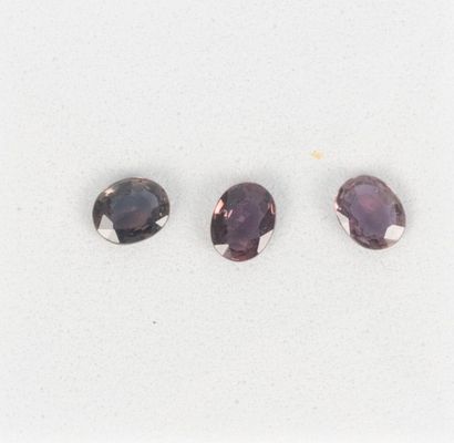 3 oval violet sapphires on paper with their...