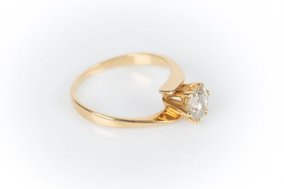 . Yellow gold solitaire set with a diamond...