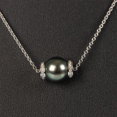 White gold pendant on its chain adorned with...