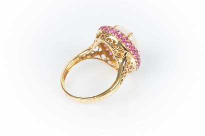 Two-tone gold ring set with an oval cabochon...