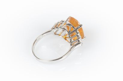 White gold ring set with a fire opal weighing...