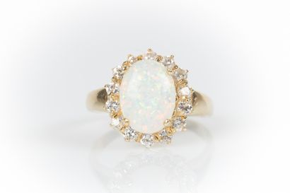 Yellow gold daisy ring set with an oval cabochon...