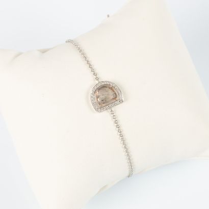 Two-tone gold bracelet centered on a faceted...