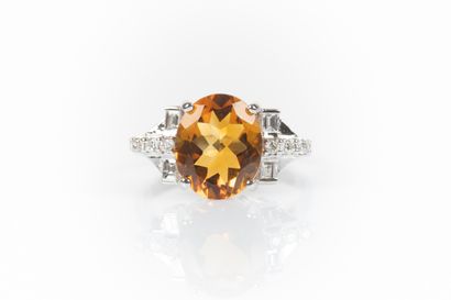 White gold ring set with an oval citrine...