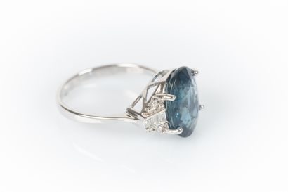 White gold ring set with a natural oval sapphire...