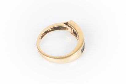 Gold ring set with calibrated gemstones in...