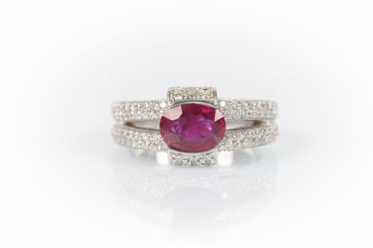 White gold ring set with an oval ruby weighing...